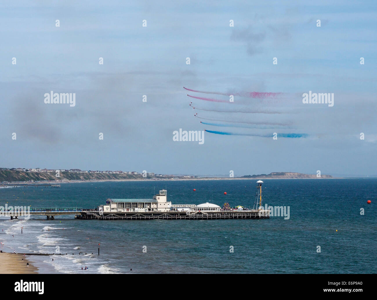 Red Arrows display at Bournemouth Air Festival over the Pier and Poole Bay, Dorset, England, UK Stock Photo