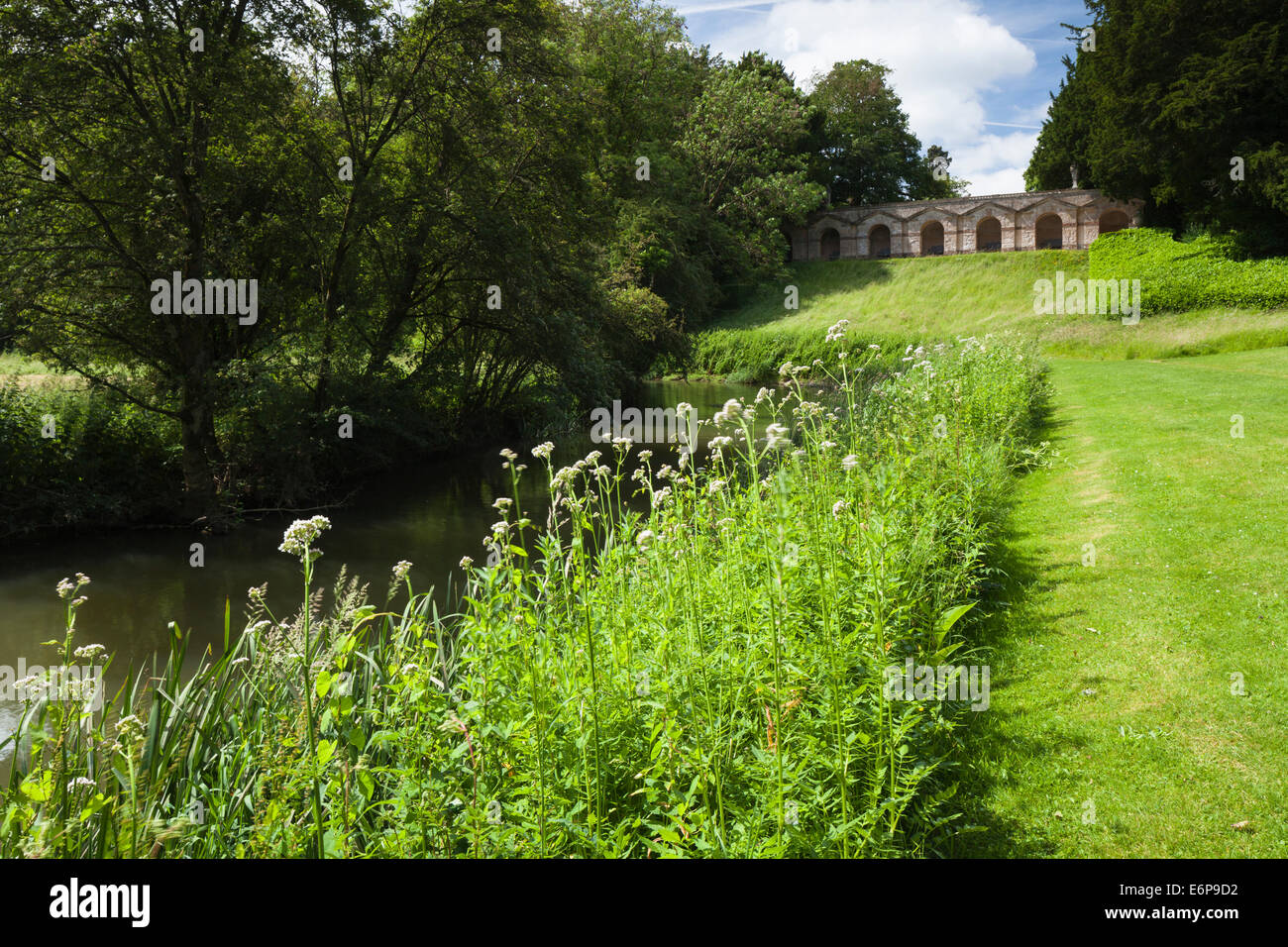 The seven-arch arcade designed by William Kent seen from beside the River Cherwell at Rousham House in Oxfordshire, England Stock Photo