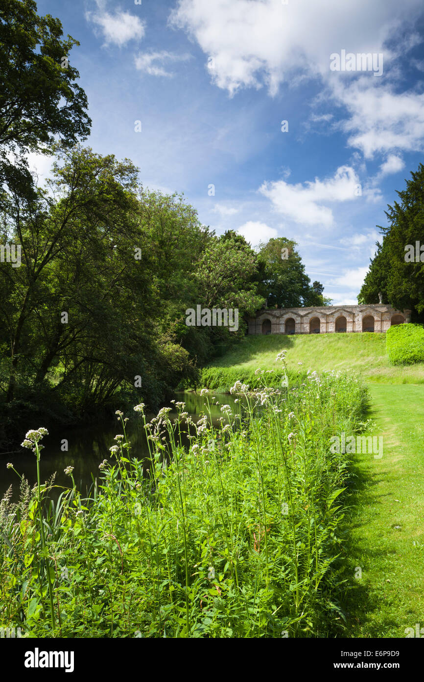 The seven-arch arcade (Praeneste) designed by William Kent seen from beside the River Cherwell at Rousham House in Oxfordshire, England Stock Photo