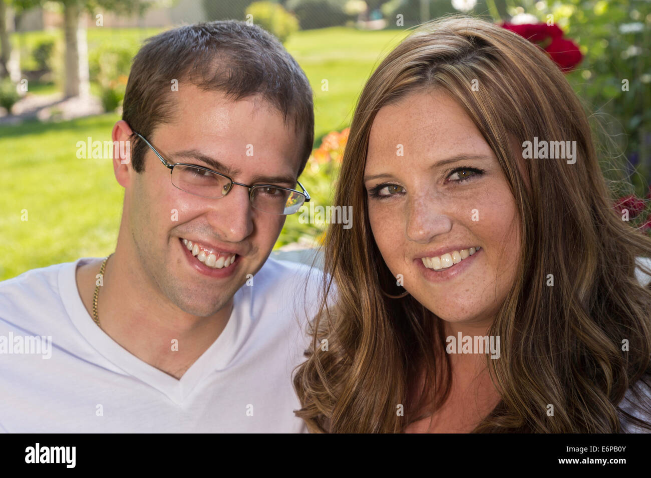 Happy Young Couple Smiling at Camera, USA Stock Photo - Alamy