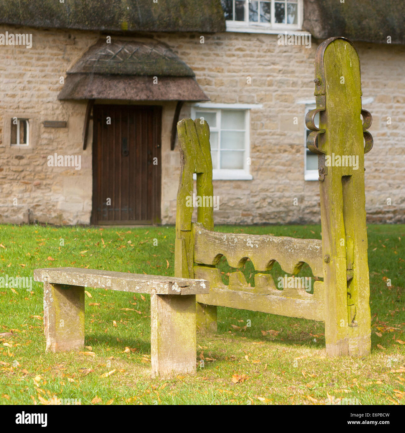 The stocks and whipping post on the village green at Market Overton near Oakham in Rutland, England, UK Stock Photo