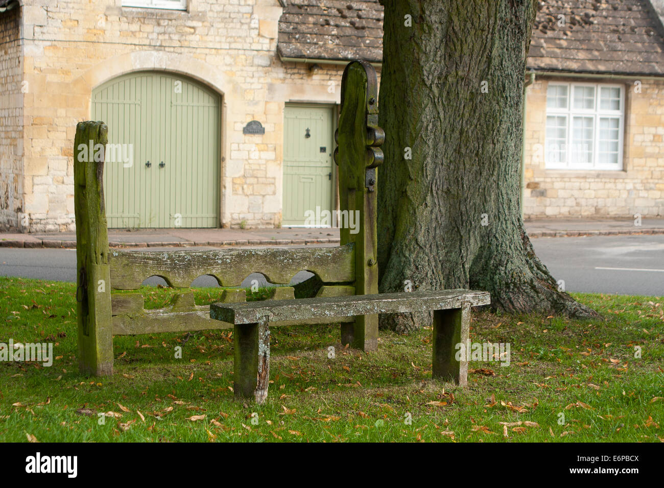 The stocks and whipping post on the village green at Market Overton near Oakham in Rutland, England, UK Stock Photo
