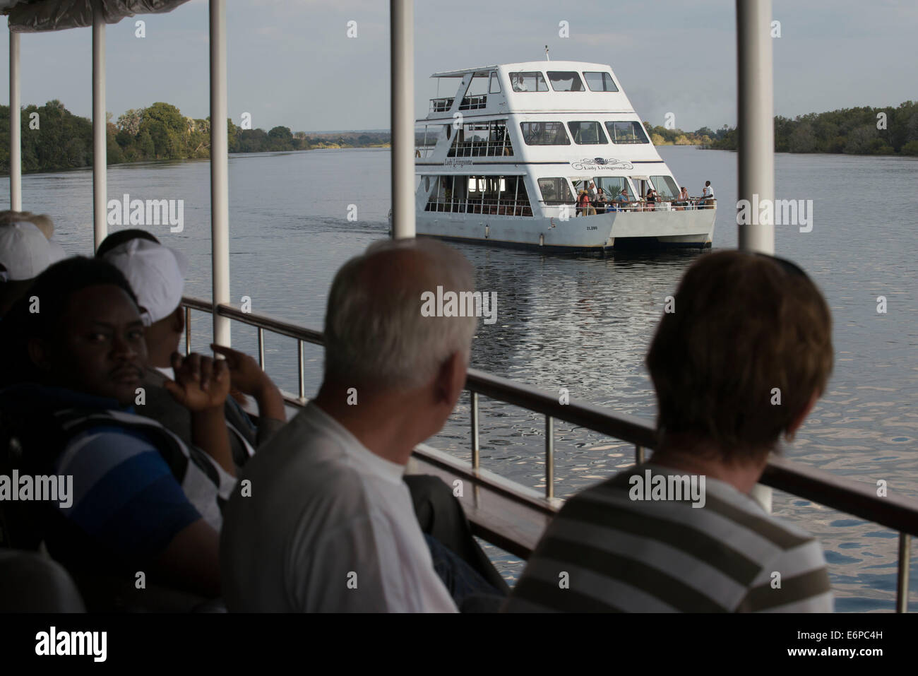 Cruise along the Victoria Falls aboard the ' African Queen'.  Other boats sailing in the Zambezi River. This is the “Lady Living Stock Photo