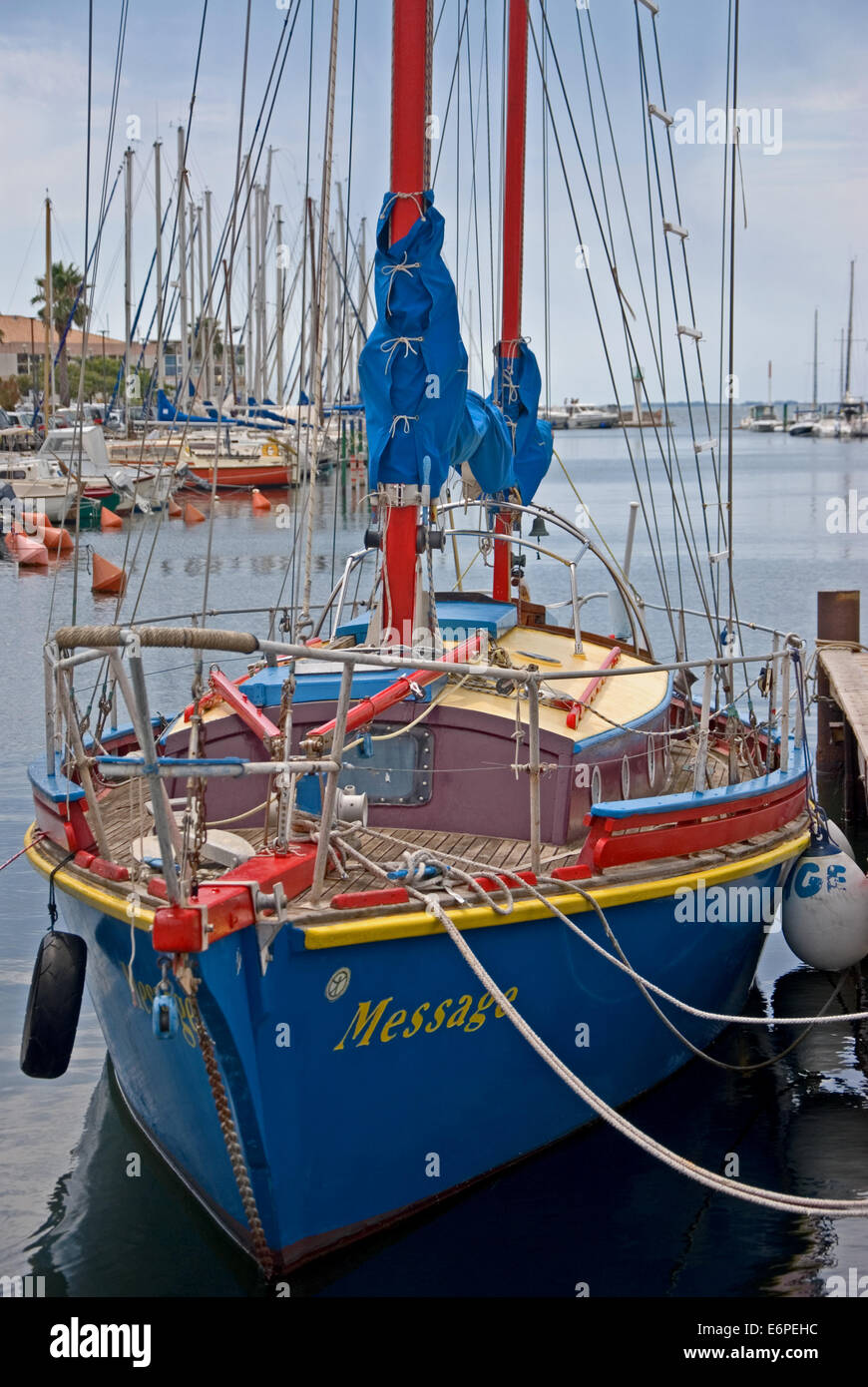 Traditional coloured sailing boat moored to the quayside in the small port of Meze, on the Bassin de Thau in southern France. Stock Photo