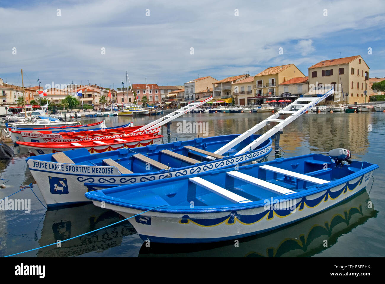 Meze harbour in the South of France, with unique joust boats moored to the quayside. Joust is a boat based sport unique to the Bassin de Thau towns. Stock Photo