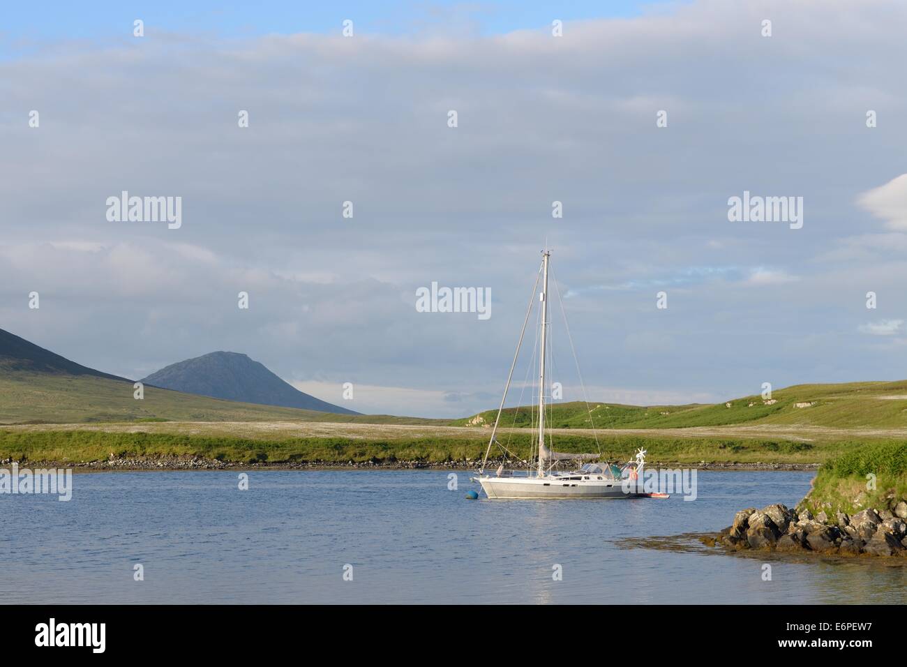 Yacht moored in the bay off Lochmaddy, North Uist, Outer Hebrides, Scotland Stock Photo