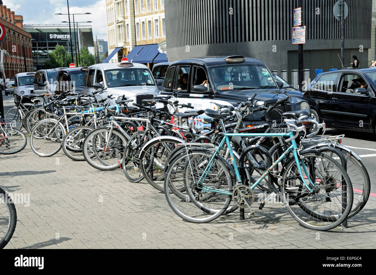 Bike racks and taxies with St Pancras Station behind London England