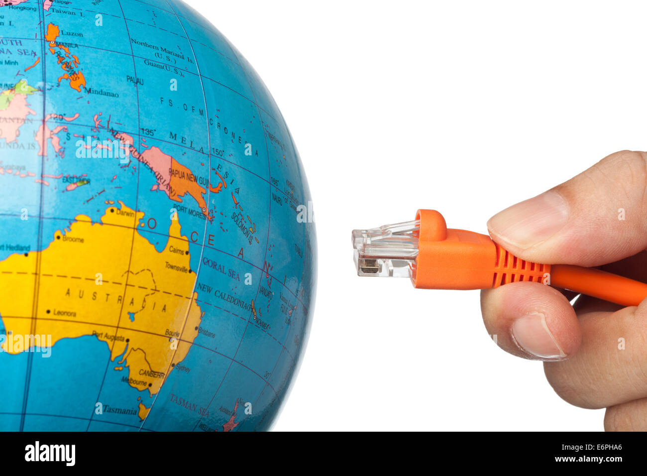 Hand plugging a network cable to the world isolated on white background Stock Photo
