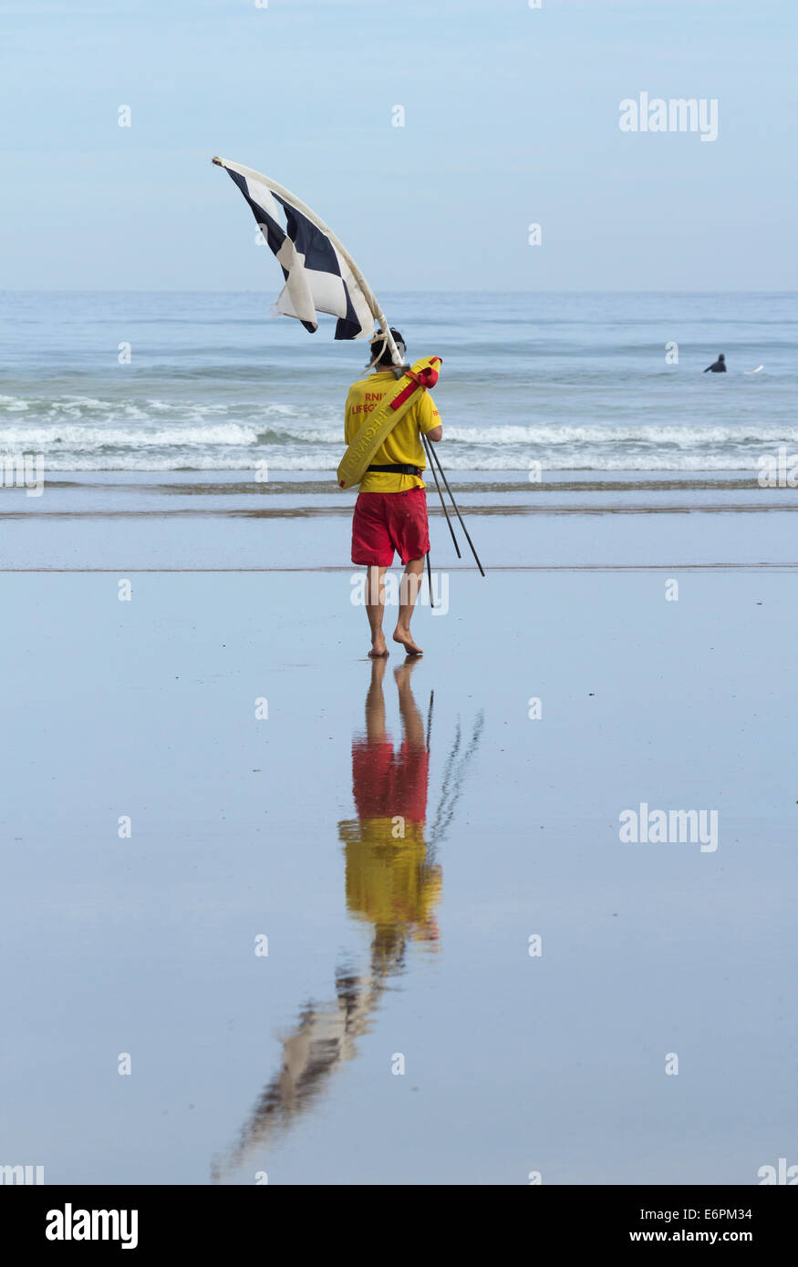 Lifeguard with safe swimming area flags at Saltburn by the Sea, North
