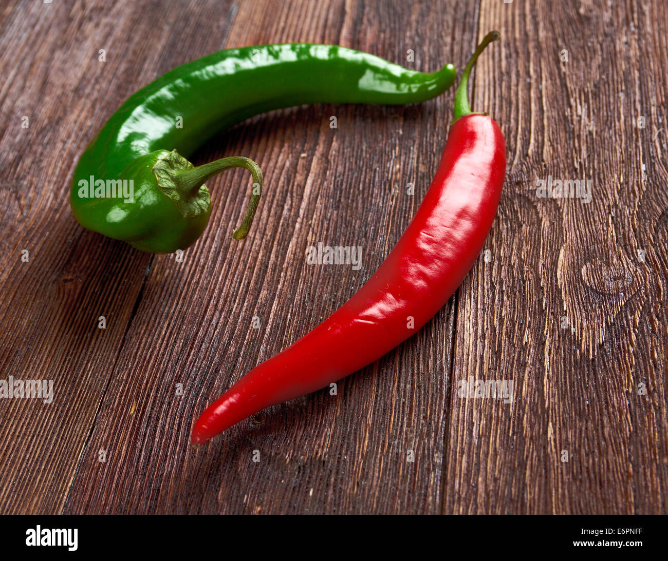 Red and green Hot Chili Peppers over wooden background Stock Photo - Alamy