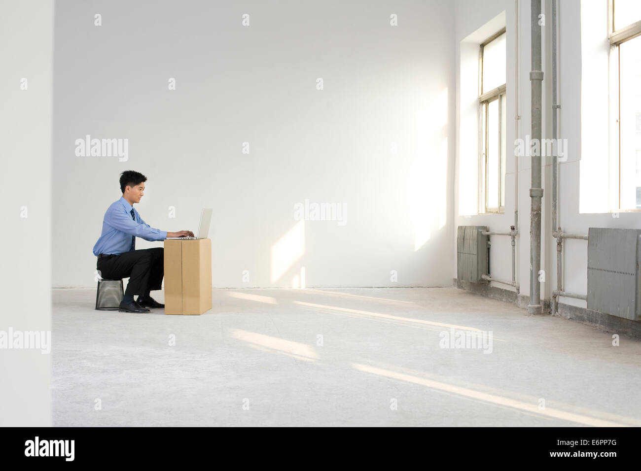 Businessman working in an empty office space Stock Photo