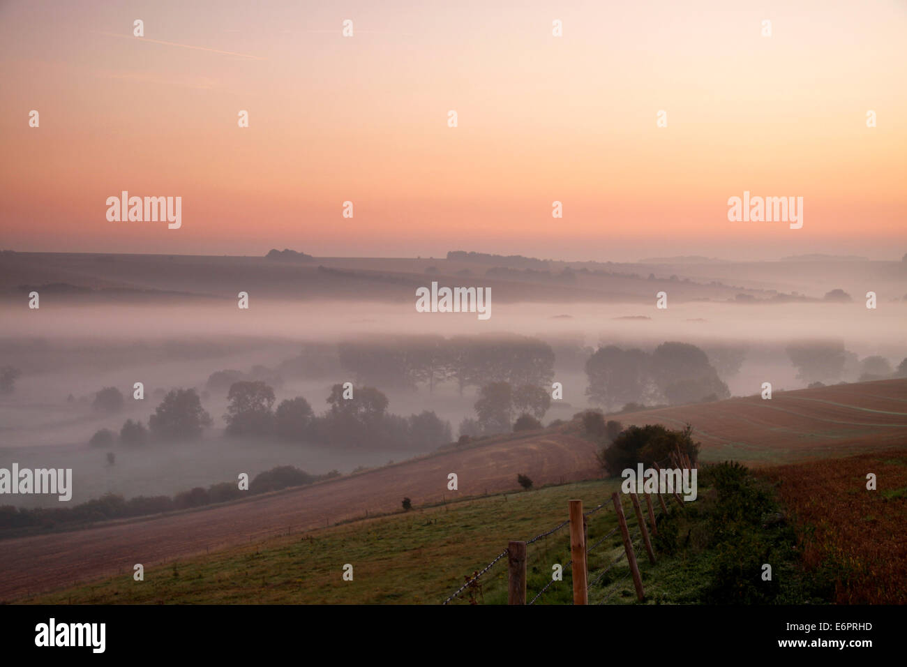 Autumn mist in the Wylye Valley, Wiltshire, England, photographed from Ebsbury Hill near the village of Great Wishford. Stock Photo