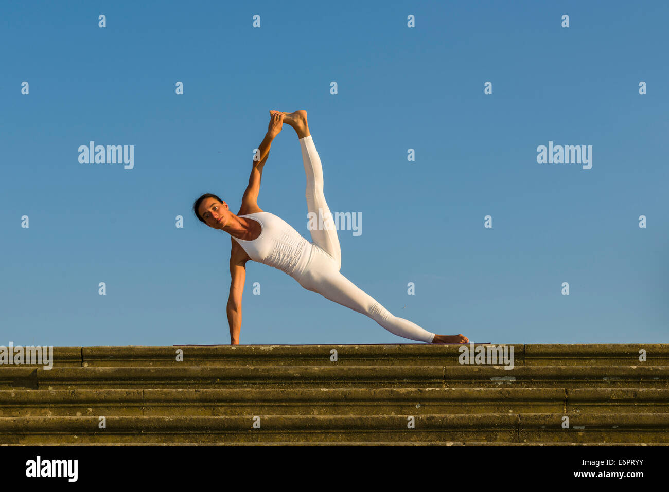 Young woman practising Hatha yoga, outdoors, showing the pose Vasisthasana, Sage Vashishta's pose Stock Photo