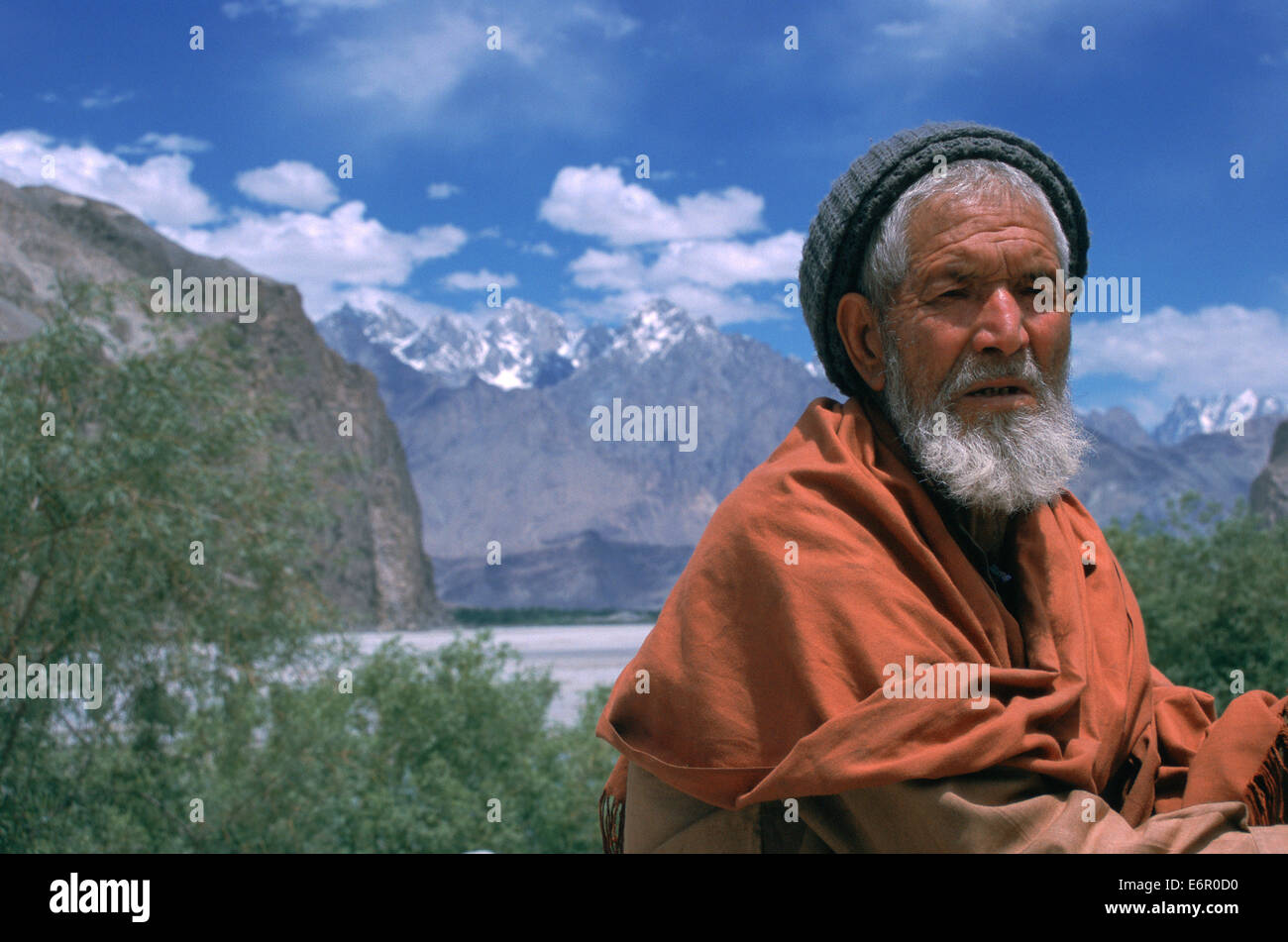 Man belonging to the Balti people surrounded by mountains ( Pakistan) Stock Photo