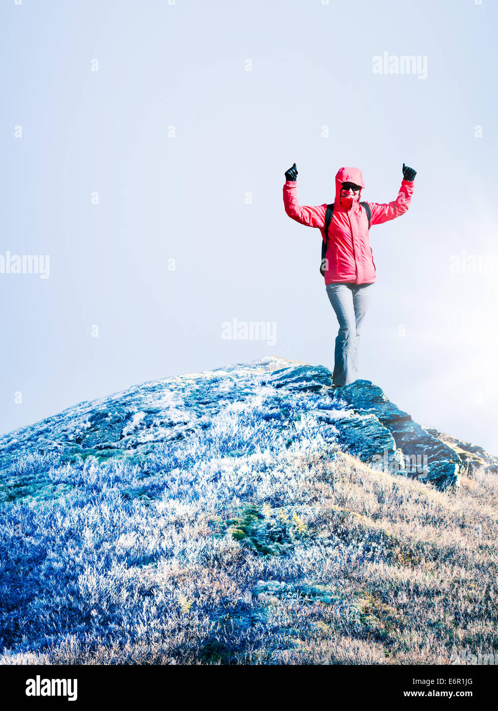 Woman at the top of mountain at cold autumn day. Space for text Stock Photo