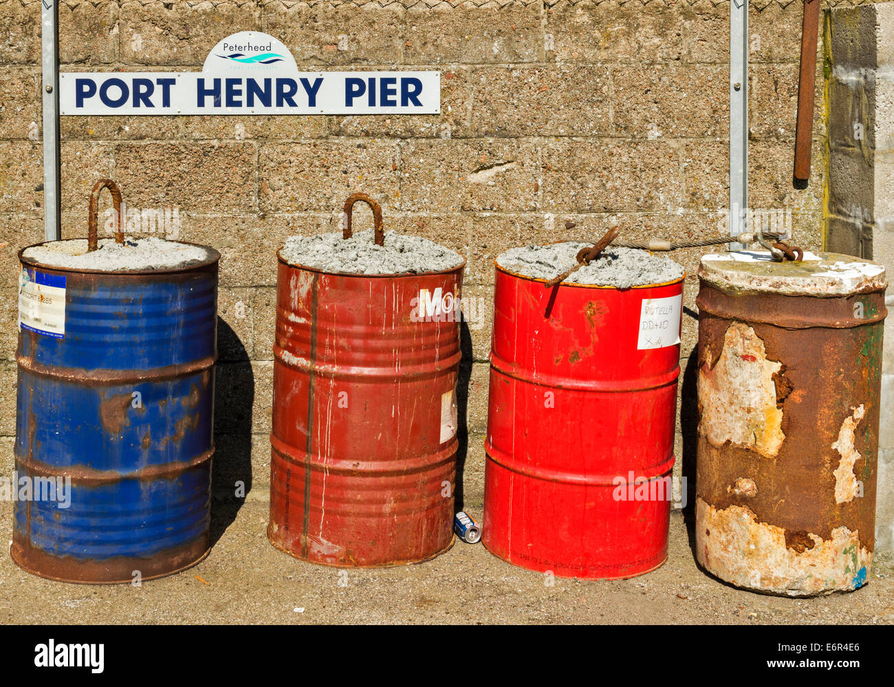 PETERHEAD HARBOUR ABERDEENSHIRE BARRELS OF CONCRETE ON PORT HENRY PIER Stock Photo