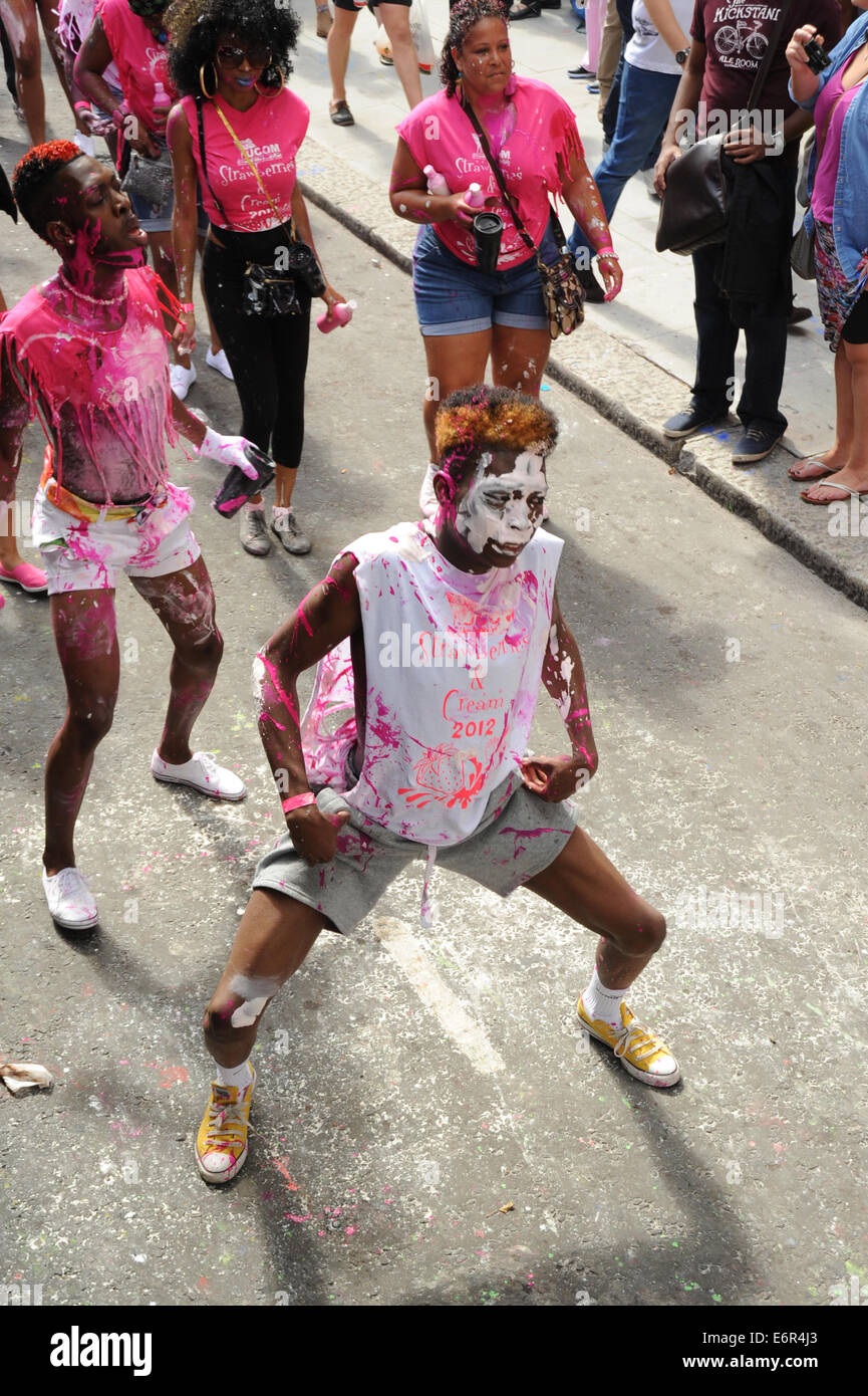 Young man Dancing covered in pink and white paint Stock Photo