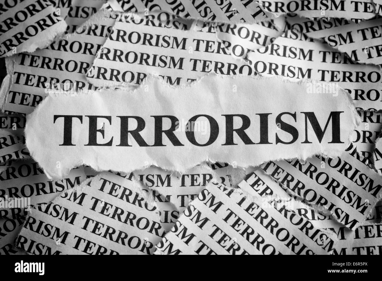 Torn pieces of paper with the word "Terrorism". Concept Image. Black