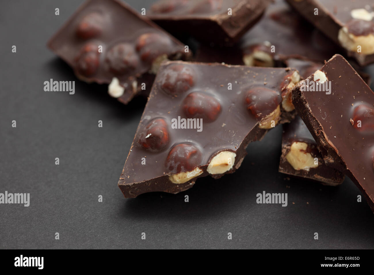 Pieces of chocolate on black background. Close-up. Stock Photo