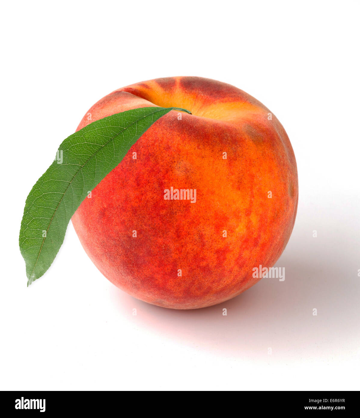 Single peach with leaves on a white background Stock Photo - Alamy