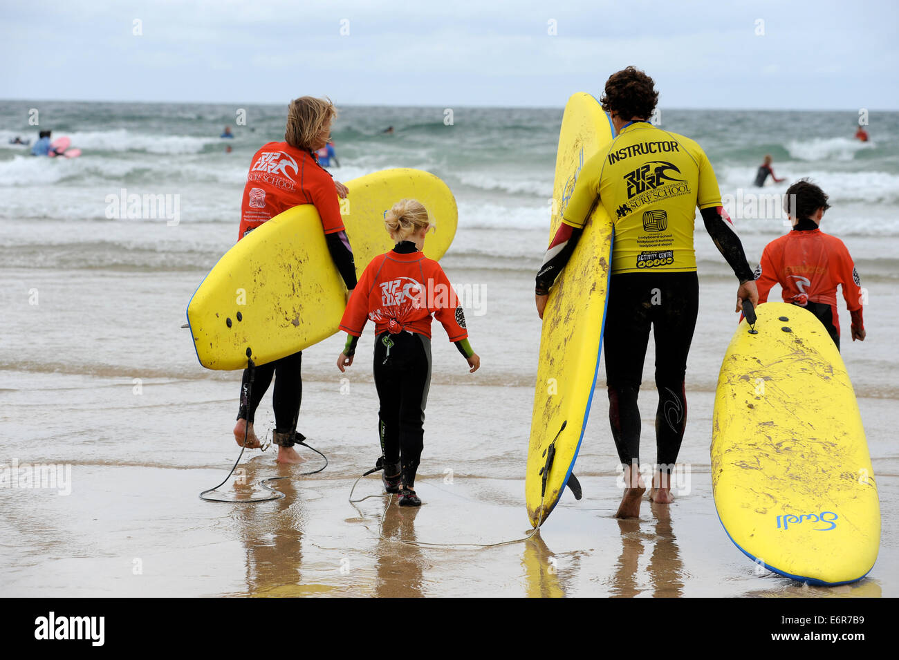 Family learning to surf in Newquay in Cornwall . uk Stock Photo Alamy