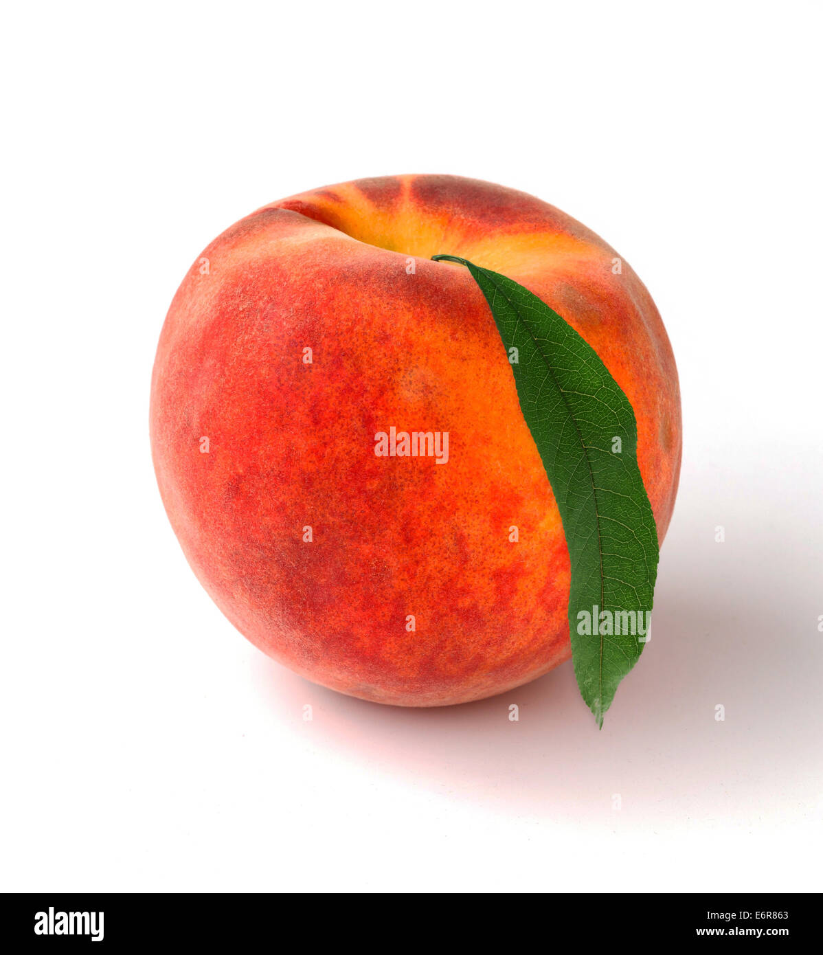 Single peach with leaves on a white background Stock Photo - Alamy