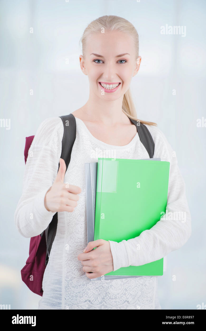 Teenage student showing thumb up Stock Photo - Alamy