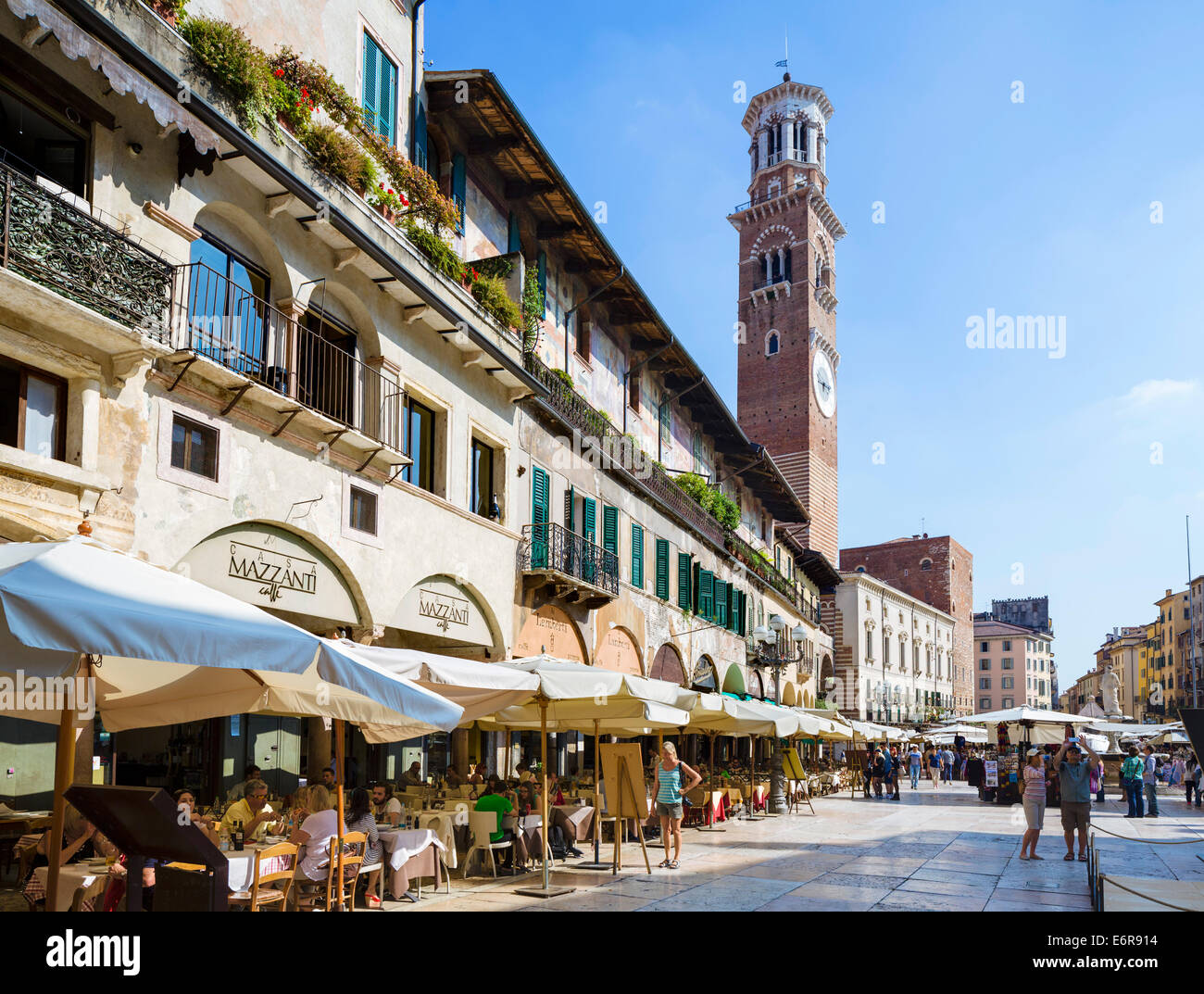 Restaurants on the Piazza delle Erbe looking towards the Torre dei Lamberti, Verona, Veneto, Italy Stock Photo