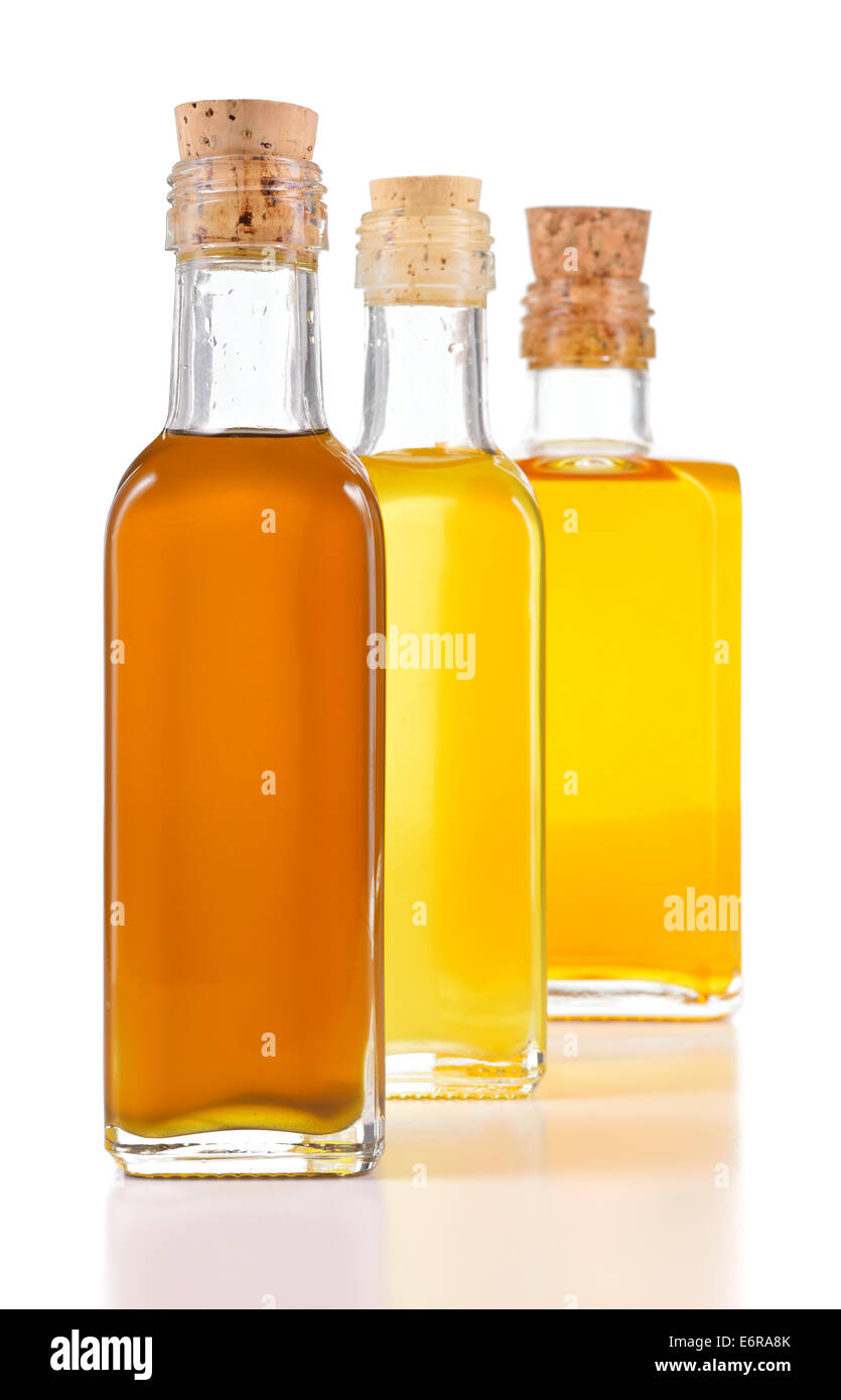 Healthy oils with unsaturated fats. Nigella sativa oil, poppy seed oil and flax oil in a bottle isolated on white background. Stock Photo