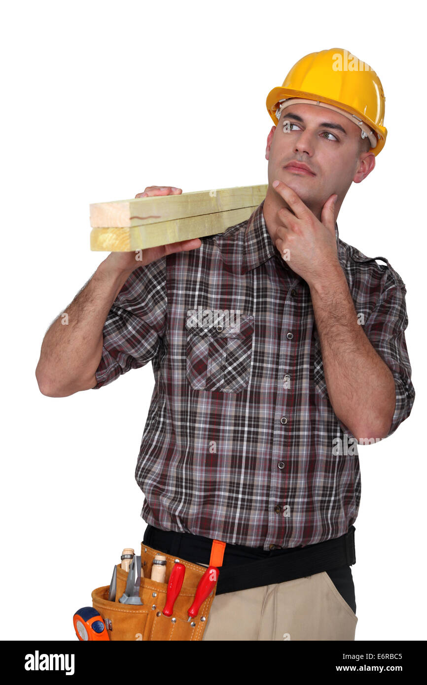 Carpenter carrying lumber Stock Photo - Alamy