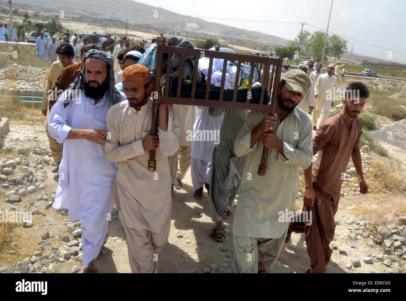 People carrying funeral of Muhammad Idrees, a journalist who assailant by unknown gunmen, at a graveyard in Quetta on Friday, August 29, 2014. Stock Photo
