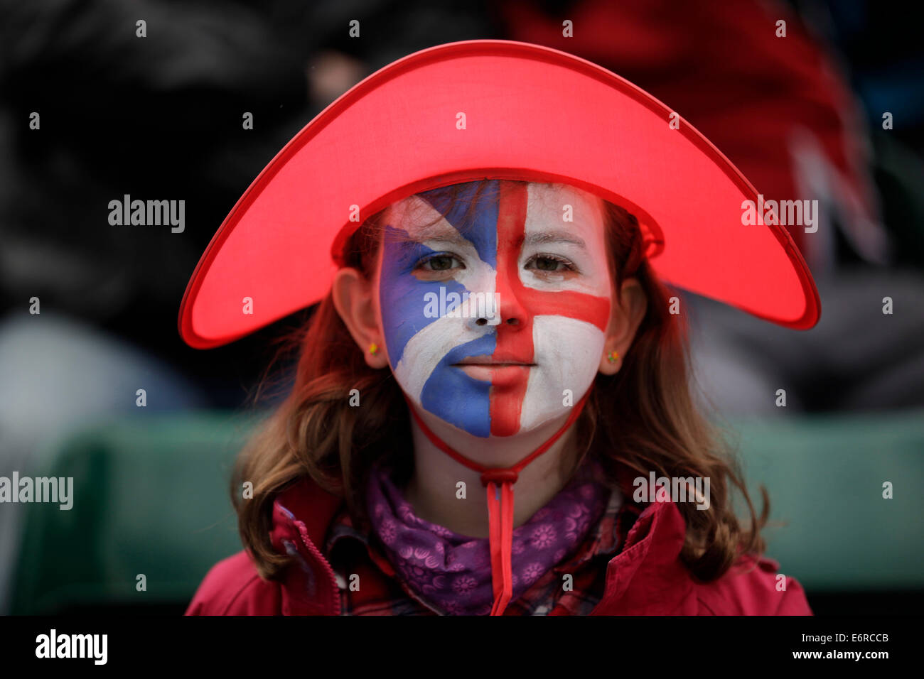 Little girl with face painted with Scottish flag and English flag Stock Photo