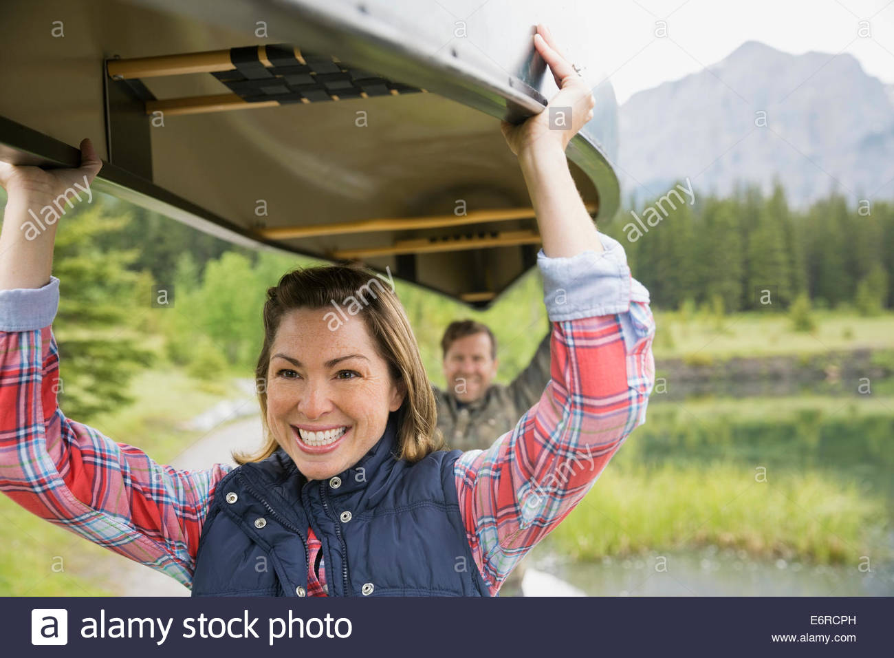 Couple carrying canoe outdoors Stock Photo Alamy