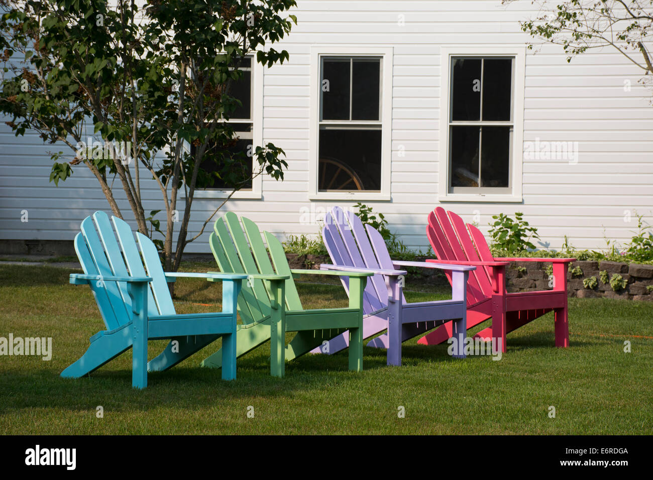 Michigan, Mackinac Island. Colorful Adirondack chairs on lawn Stock