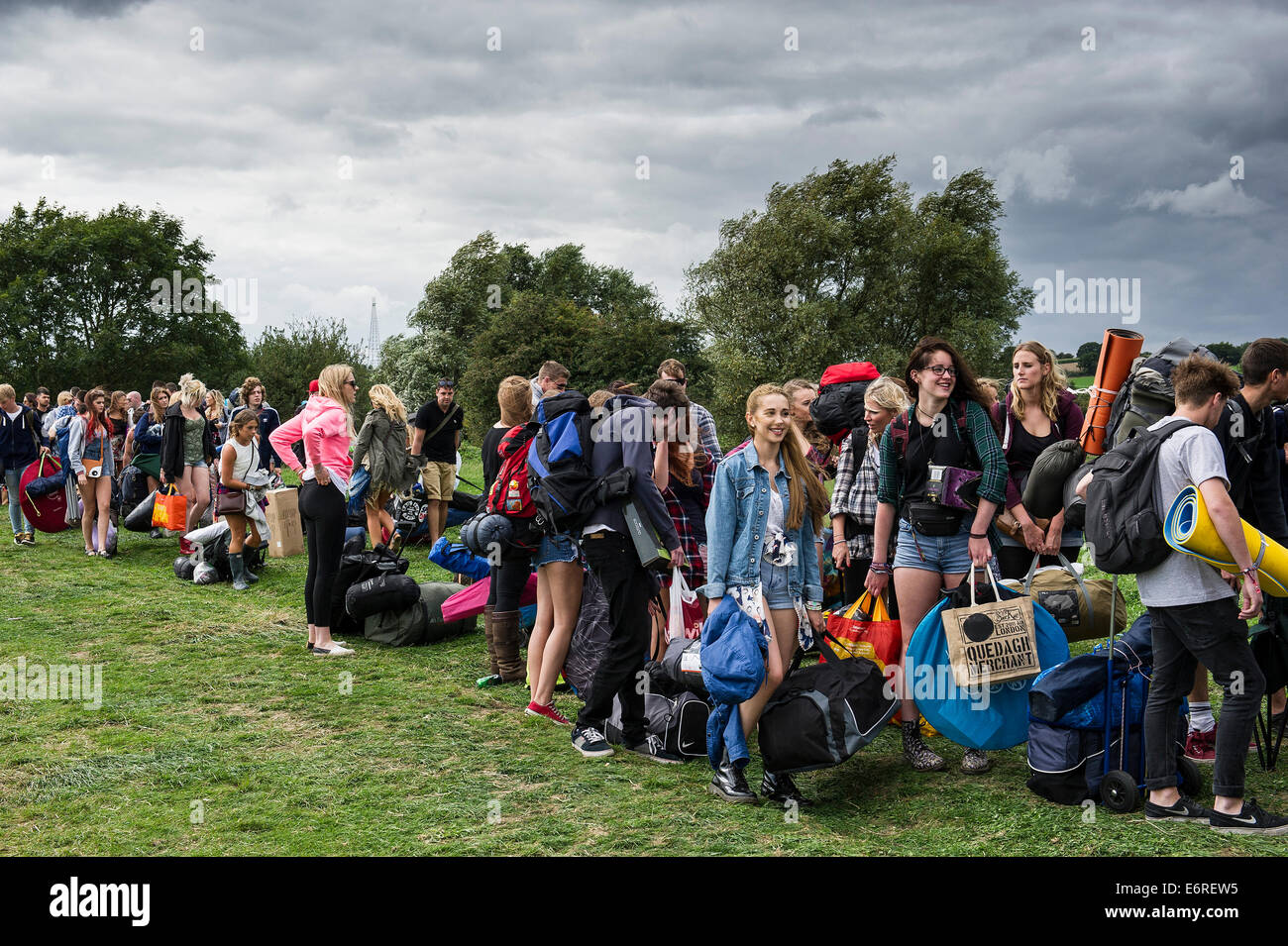 Young people queue to gain access to a music festival. Stock Photo