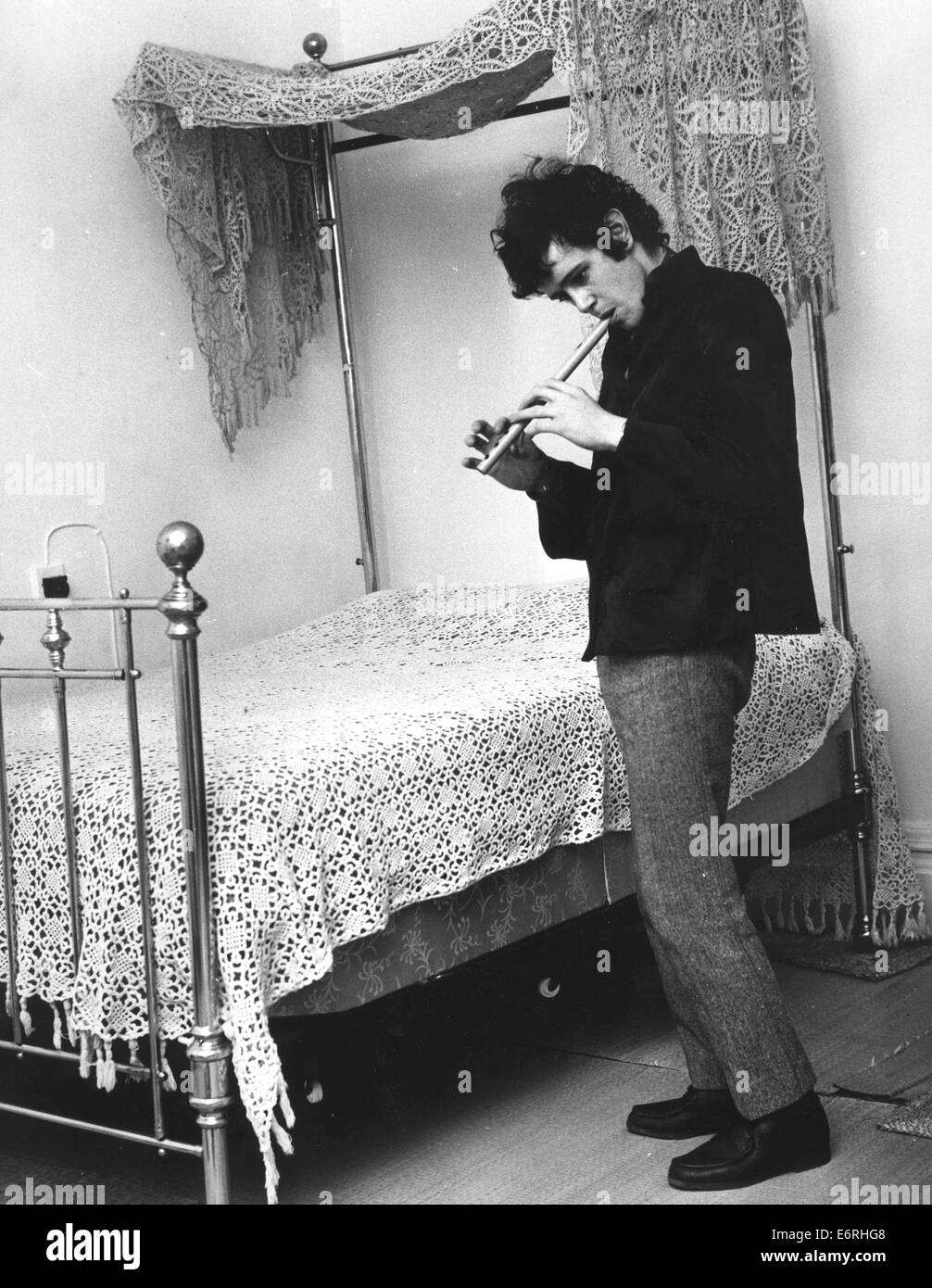 London, UK, UK. 2nd Oct, 1970. DONOVAN (born DONOVAN PHILIPS LEITCH, 10 May 1946) is a Scottish singer, songwriter and guitarist. He developed an eclectic and distinctive style that blended folk, jazz, pop, psychedelia, and world music (notably calypso). PICTURED - Maida Vale, Paddington, London, England - Singer musician DONOVAN, 19, relaxing at Maida Vale home playing a folksy tune on a wooden flute wind instrument recorder beside his Victorian brass bed with lace crocheted canopy. © KEYSTONE Pictures/ZUMAPRESS.com/Alamy Live News Stock Photo