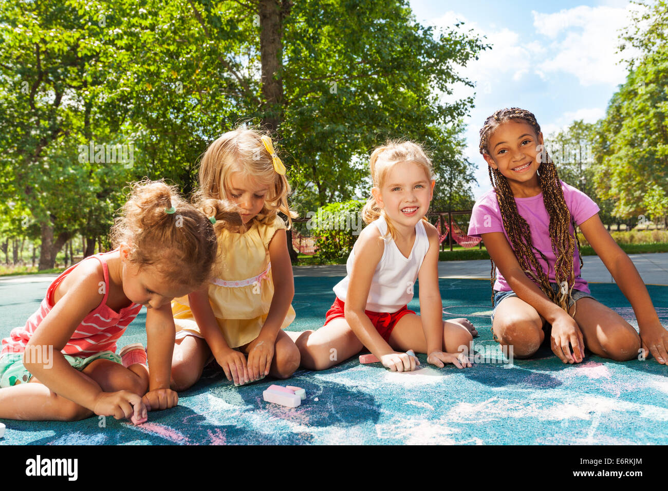 Girls draw image with chalk on playground Stock Photo - Alamy