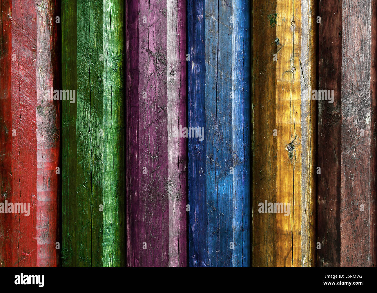 Wall of rough wooden poles painted in several colors Stock Photo