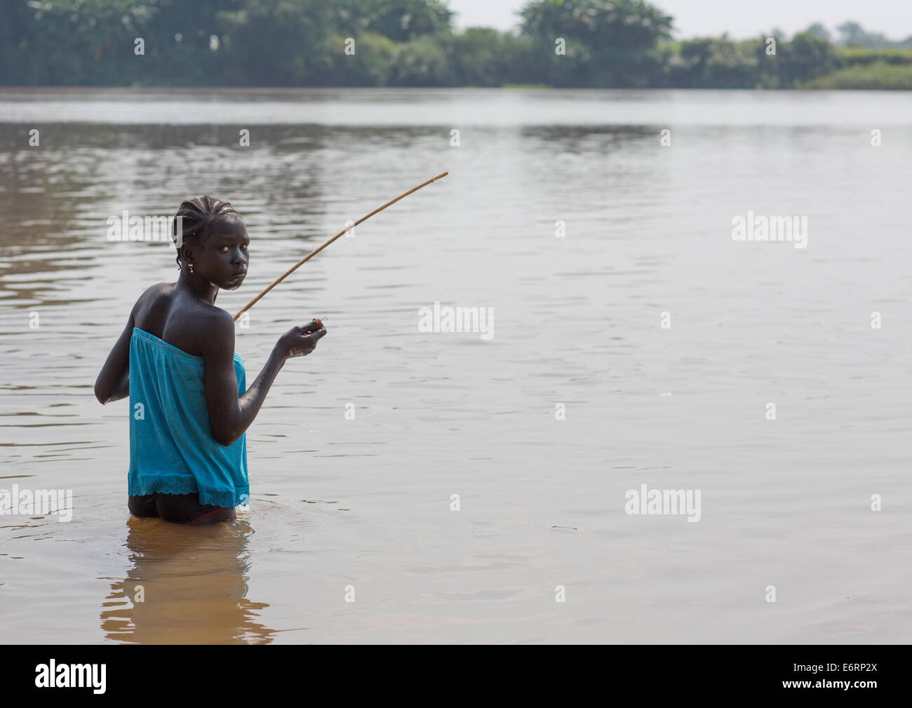 Anuak Tribe Girl Fishing On Baro River, Gambela, Ethiopia Stock Photo