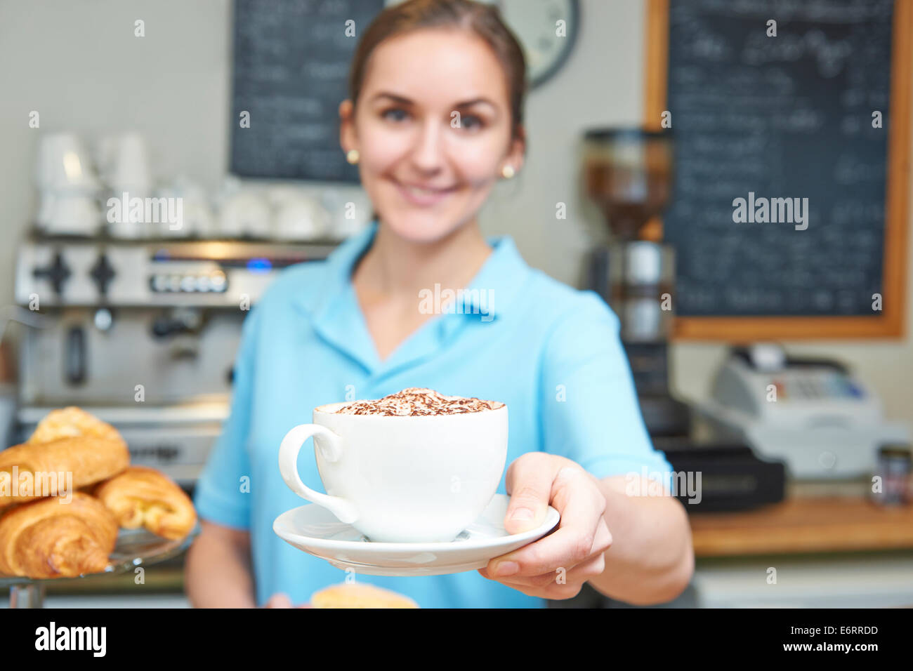 Waitress In Cafe Serving Customer With Coffee Stock Photo