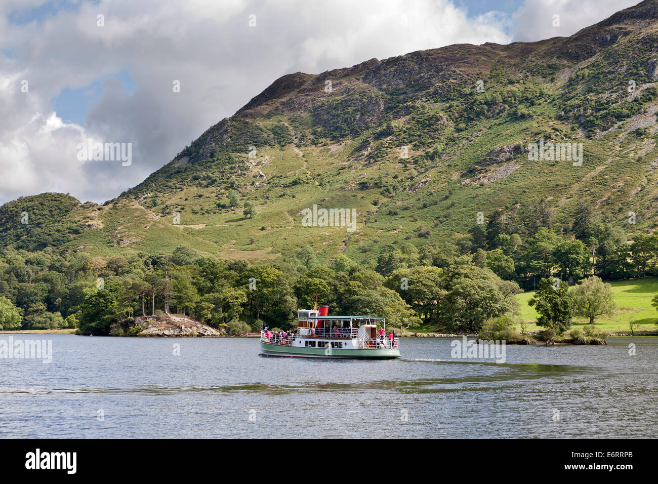 Ullswater Steamer M V Western Belle from behind in the distance with the Fells in the background, Cumbria Lake District England Stock Photo