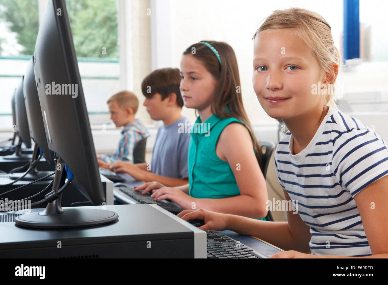 Group Of Elementary School Children In Computer Class Stock Photo - Alamy