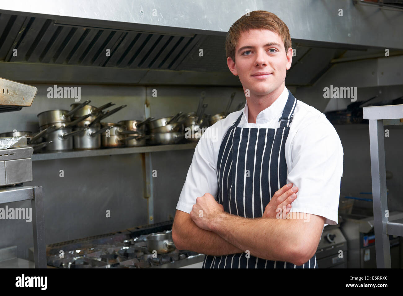 Portrait Of Chef In Restaurant Kitchen Stock Photo