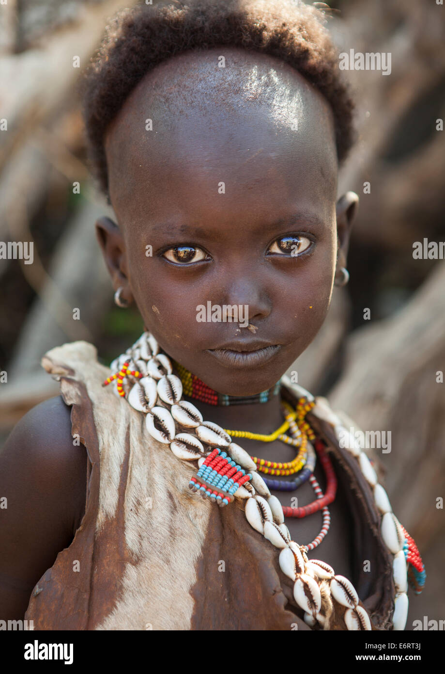 Litte Hamer Girl Tribe With Head Half Shaved In Traditional Outfit, Turmi, Omo Valley, Ethiopia Stock Photo