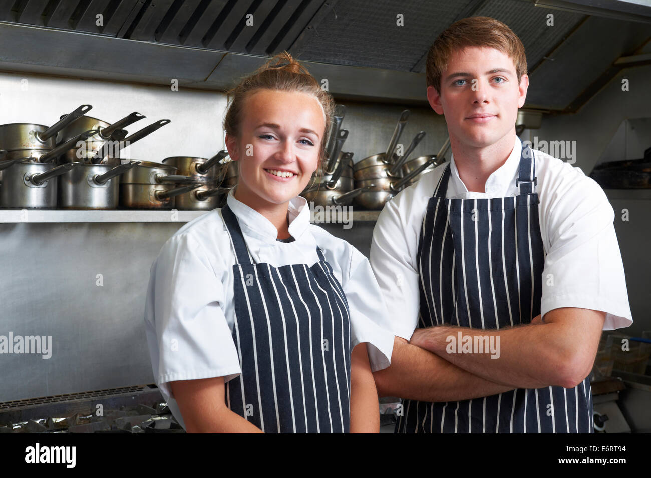 Portrait Of Chef And Trainee In Kitchen Stock Photo