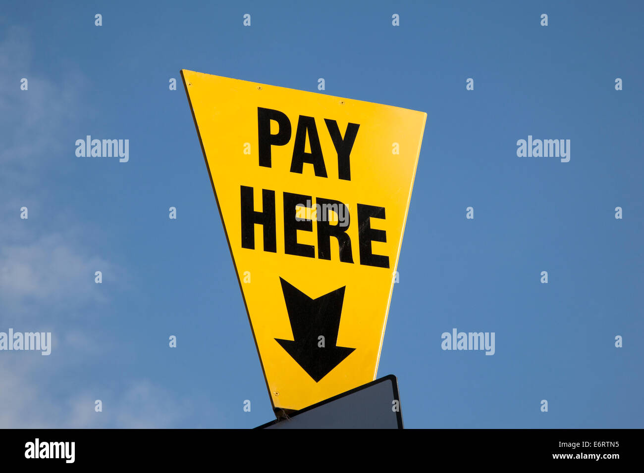 Yellow Pay Here Sign in Car Park Stock Photo