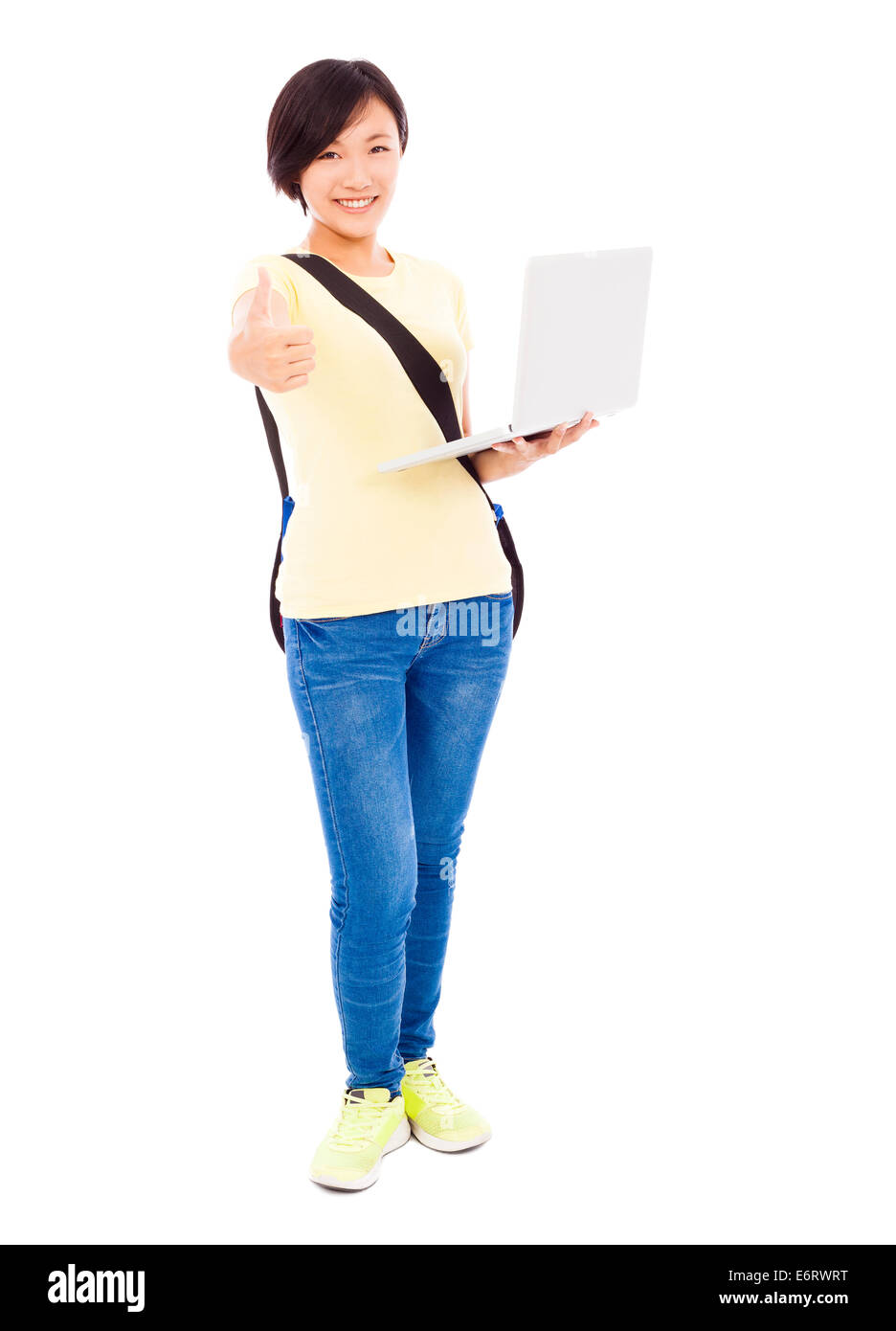 Smiling young woman holding a laptop and thumb up Stock Photo