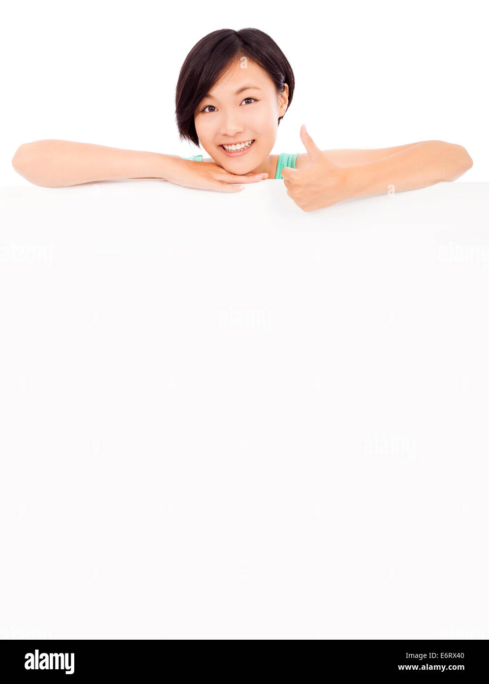 smiling pretty young girl thumb up with blank board Stock Photo