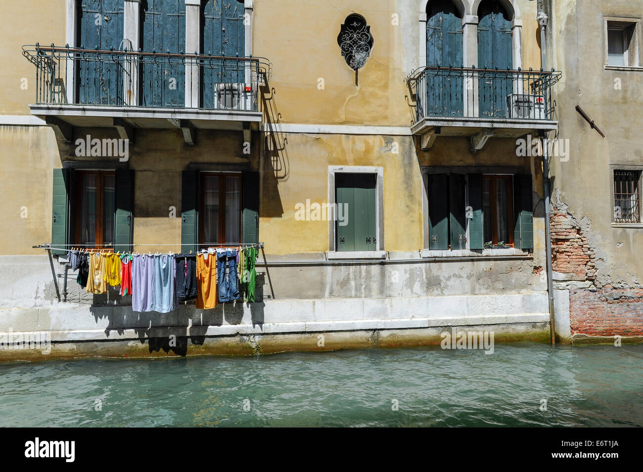 Washing hanging to dry above one of many canals in Venice. Stock Photo
