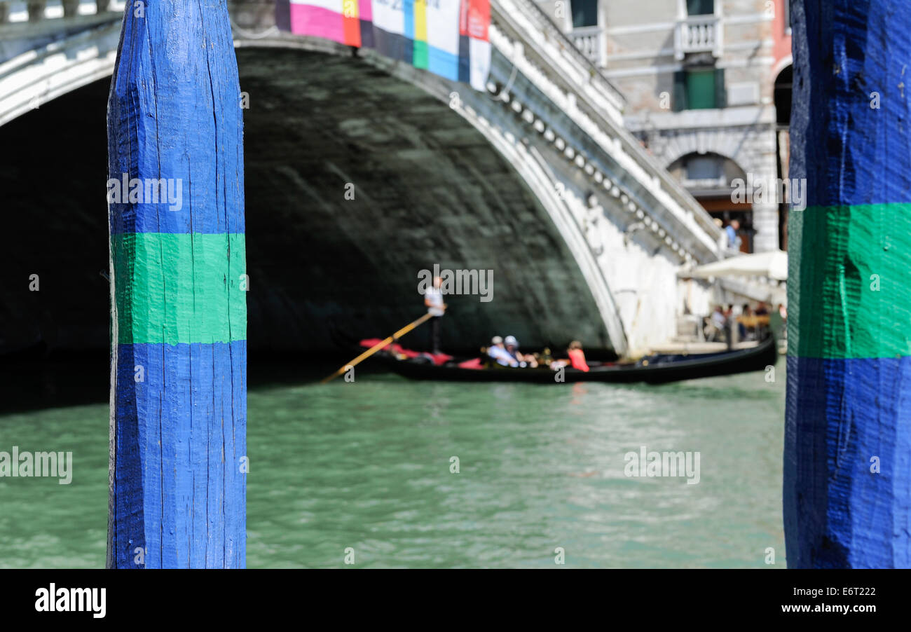 Colourful wooden post for mooring gondola's to at the Rialta bridge in Venice, italy Stock Photo